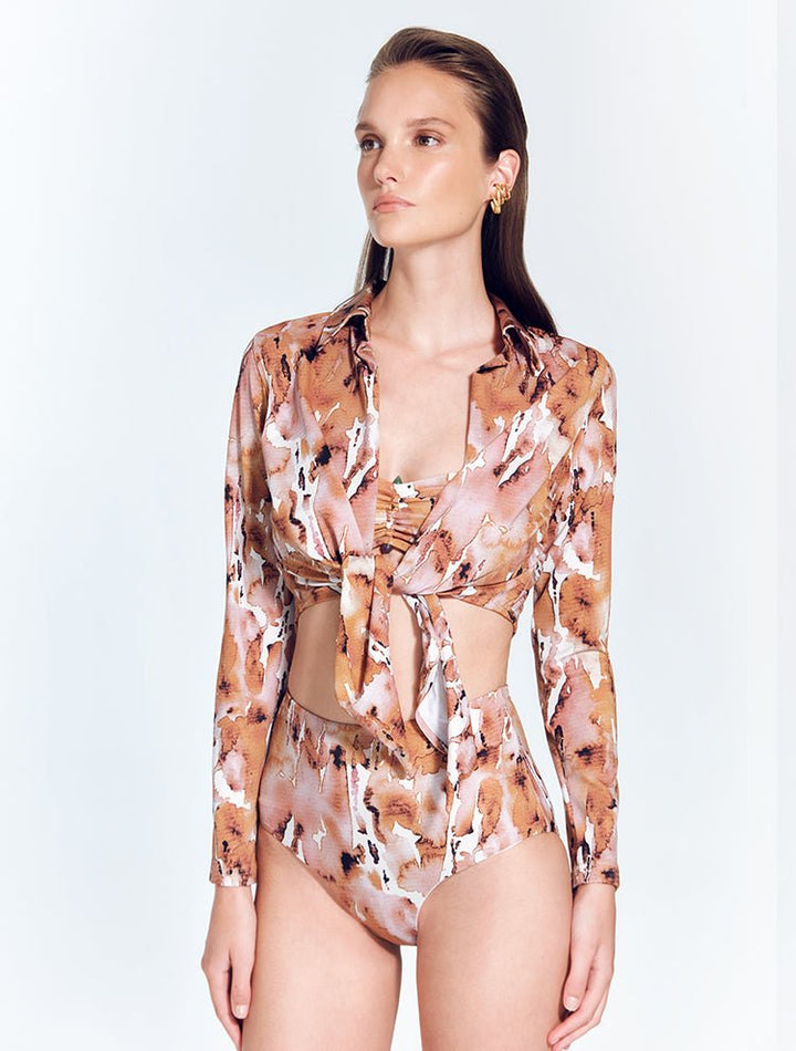 Front View: Model in Greta Floral Abstract Shirt - MOEVA Luxury Swimwear, Cropped Silhouette, Made of Swimwear Fabric, Tie at the Front, Unlined, Comfort and Day to Night, MOEVA Luxury Swimwear