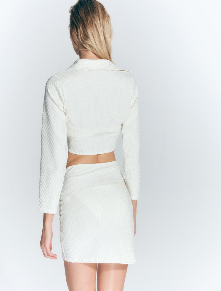 Back View: Model in Greta Seersucker White Shirt - MOEVA Luxury Swimwear, Long-Sleeved Blouse, French Fabric, Special Lycra Xtralife Certificate, MOEVA Luxury Swimwear
