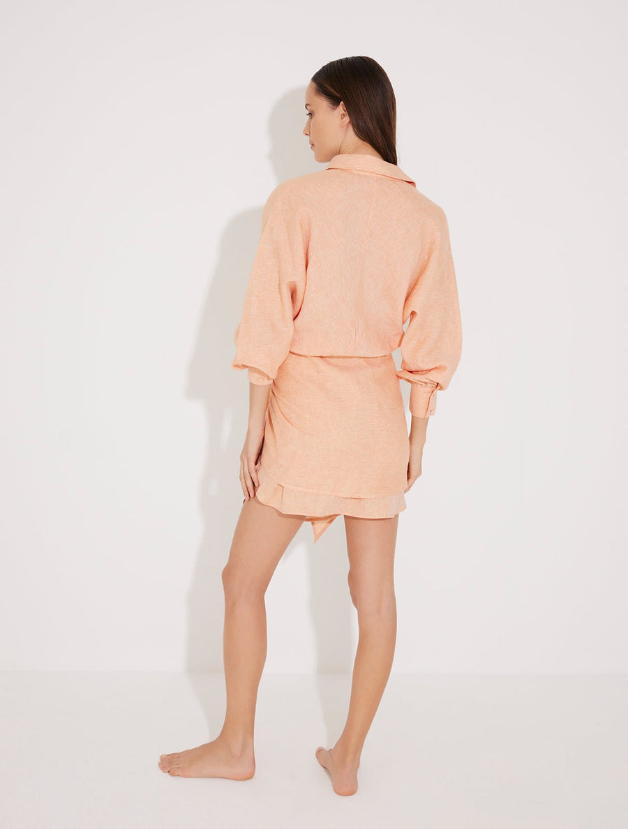 Back View: Model in Guadalupe Orange Dress - MOEVA Luxury Swimwear, Loose Silhouette, Ready to Wear Mini Dress, Unlined, Comfort Linen Shirt Dress, MOEVA Luxury Swimwear