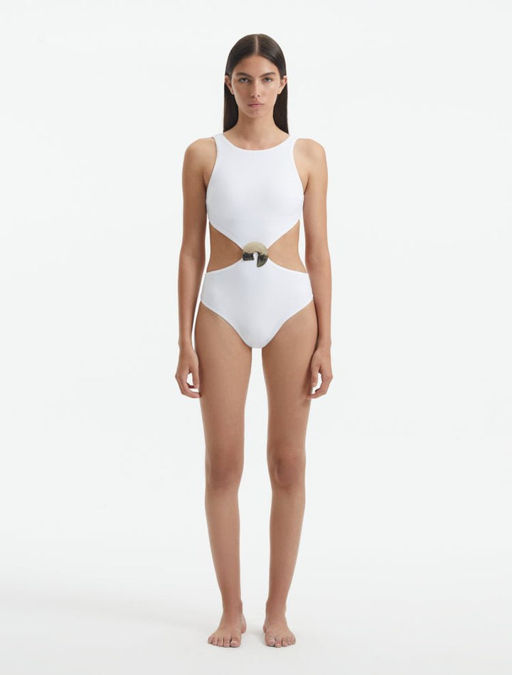 Front View: Model in Honora White Swimsuit - MOEVA Luxury Swimwear, Cut Out Silhouette, Two Halves Held Together By Accessory, Crushed Round Gold Accessory, High Neckline, MOEVA Luxury Swimwear 