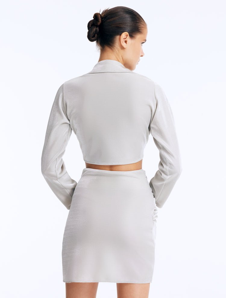 Back View: Indigo Silver Skirt on Model - Cut Out Detail, Twist Knot Detail, Clear Glass Drop Shaped Accessory, Stylish Beachwear Skirt, MOEVA Luxury Beachwear