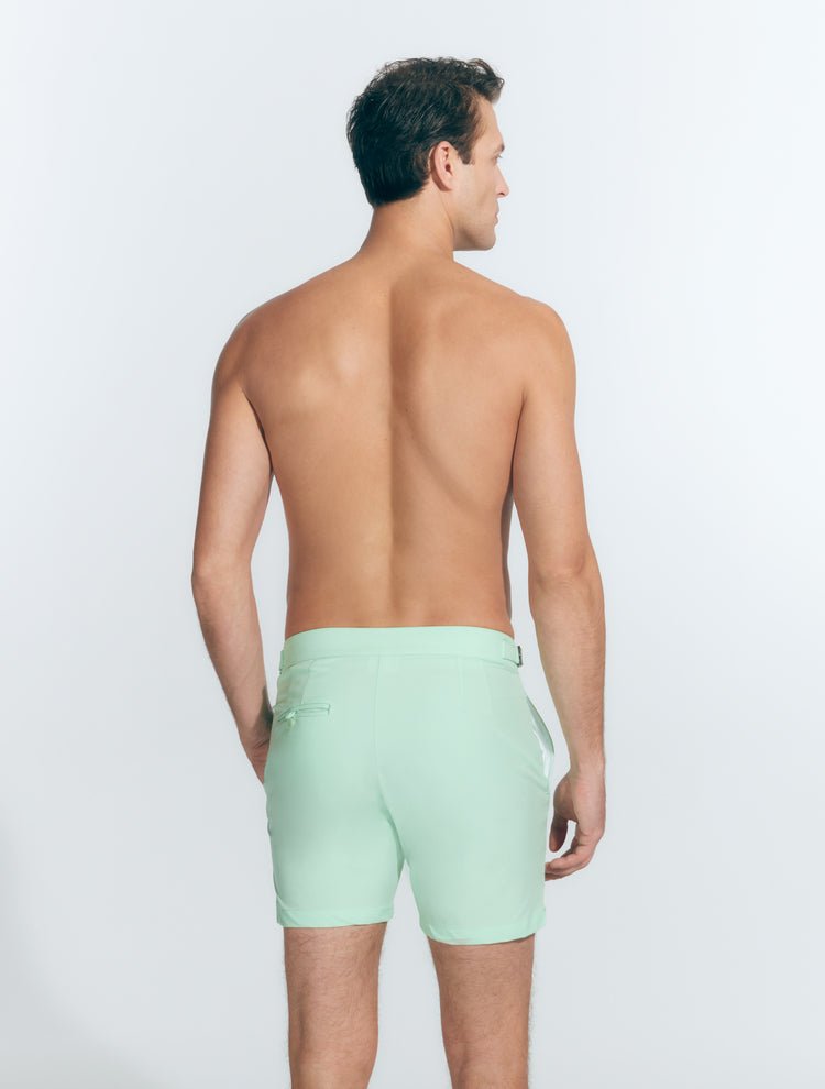 Back View: Model in Jack Light Green Shorts - MOEVA Luxury Swimwear, Nikel, Mid Length Swim Shorts, Fully Lined, Slim Fit, Strech Classic,  Buttoned Back Pockets, MOEVA Luxury Swimwear
