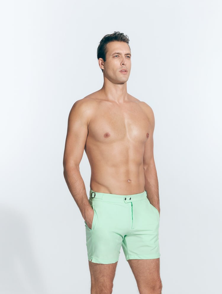 Front View: Model in Jack Light Green Shorts - MOEVA Luxury Swimwear, Slim Fitting, Lightweight Fabric with Quick Drying, Front Slash Pockets, Snap and Zip Fastening, Buckles at the Waist, Quick Dry, MOEVA Luxury Swimwear