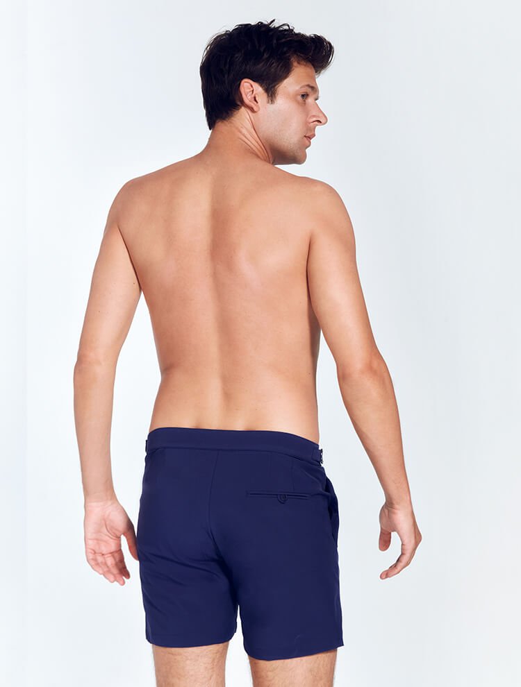 Back View: Model in Jack Navy Blue Shorts - MOEVA Luxury Swimwear, Nikel, Mid Length Swim Shorts, Fully Lined, Slim Fit, Strech Classic,  Buttoned Back Pockets, MOEVA Luxury Swimwear