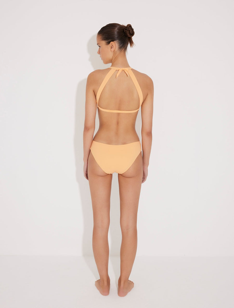 Front View: Jolanda Orange Monokini on Model - Tie Neck Swimsuit, Moderate Bottom Coverage, Italian Fabric, Crushed Round Gold Accessory, MOEVA Luxury Swimwear