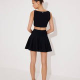 Lanao Black Cut-Out Knit Mini Dress with Gold Detail | Moeva | RTW Dresses | Each week unveils new pieces—luxury swimwear, fluid resort silhouettes, and elevated summer-to-evening essentials designed to carry you from coastal escapes to city nights.
