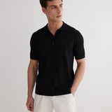Lars Black Polo Shirt with Button Fastening | Moeva | Men Classic Collar Shirts | Each week unveils new pieces—luxury swimwear, fluid resort silhouettes, and elevated summer-to-evening essentials designed to carry you from coastal escapes to city nights.