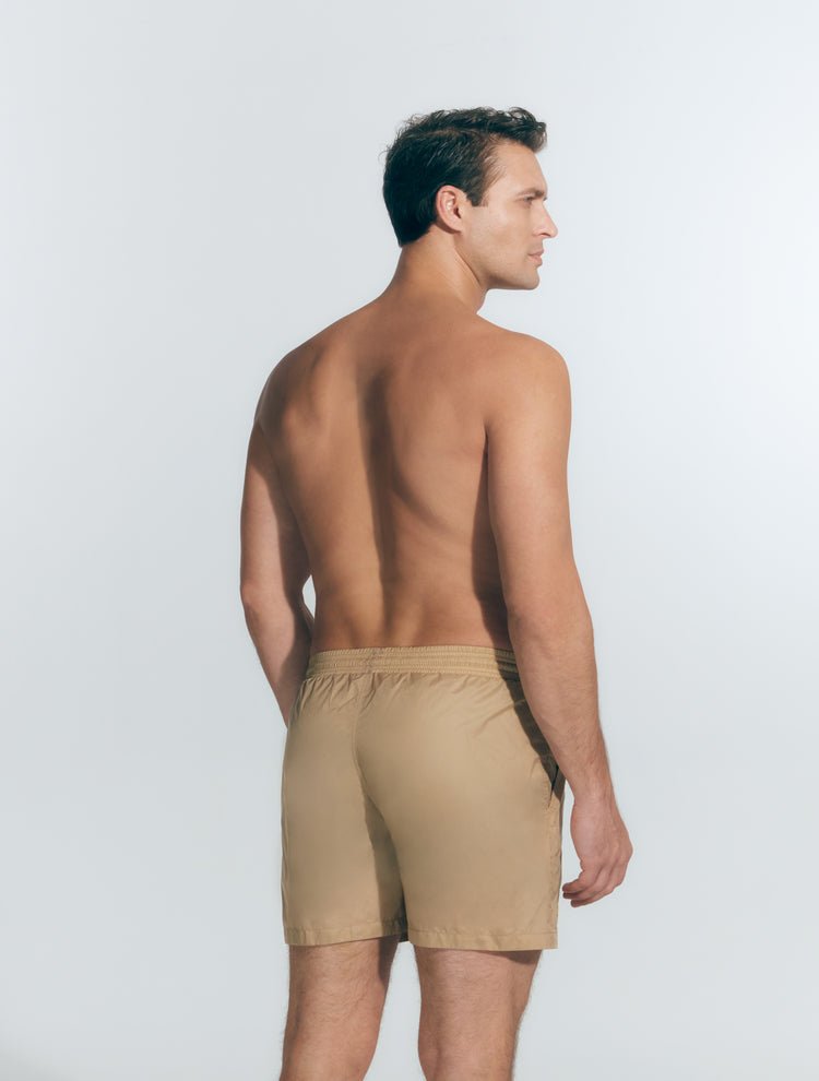 Back View: Model in Louis Beige Shorts - MOEVA Luxury Swimwear, Men Swim Shorts, Nikel, Mid Length Swim Shorts, Fully Lined, Slim Fit, Quick Dry, MOEVA Luxury Swimwear