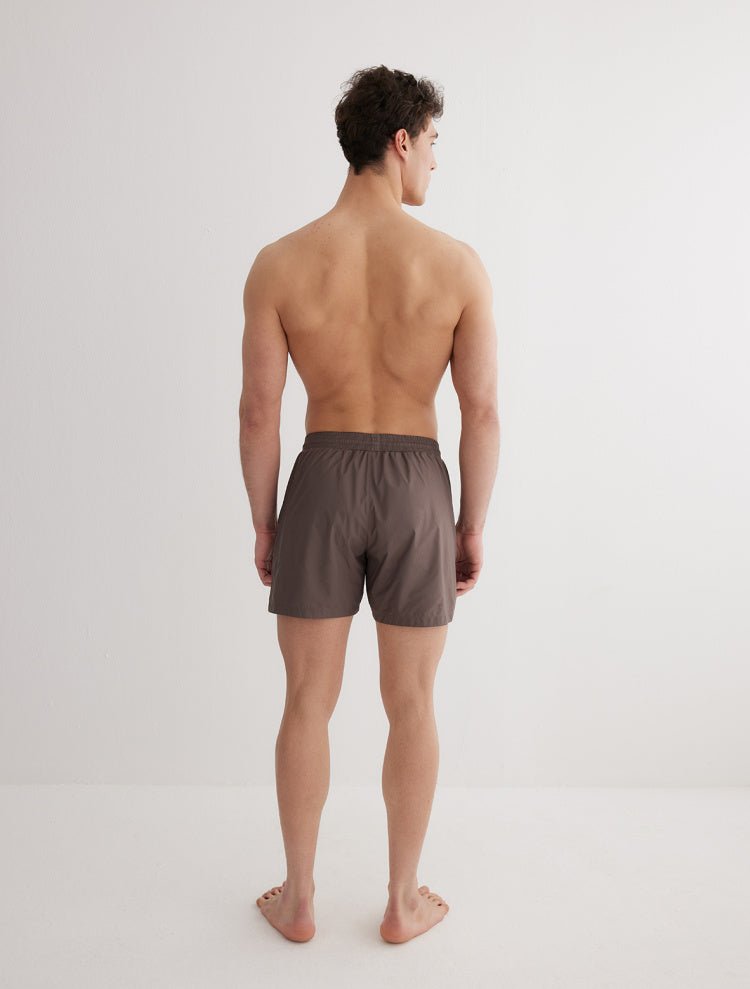 Back View: Model in Louis Grey Swim Shorts - MOEVA Luxury Swimwear, Men Swim Shorts, Nikel, Mid Length Swim Shorts, Fully Lined, Slim Fit, Quick Dry, MOEVA Luxury Swimwear