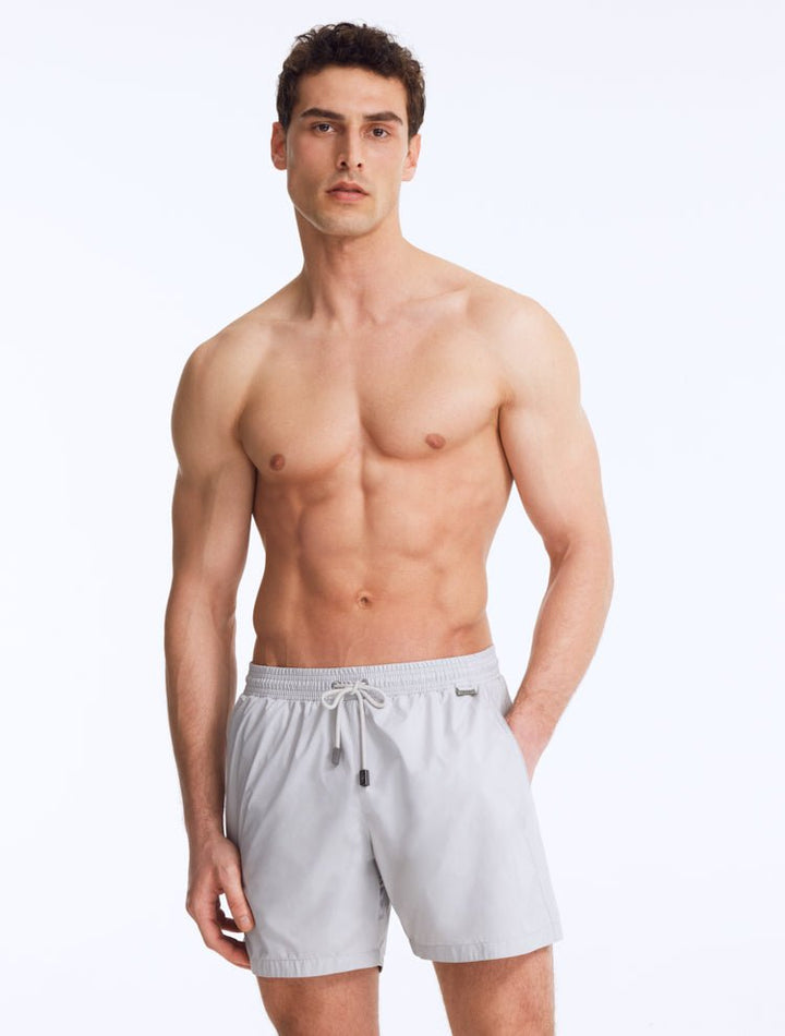 Front View of Model Wearing Louis Light Grey Shorts - MOEVA Luxury Swimwear, Close Fitting, Lightweight Fabric with Quick Drying, Pockets at the Front, MOEVA Luxury Swimwear