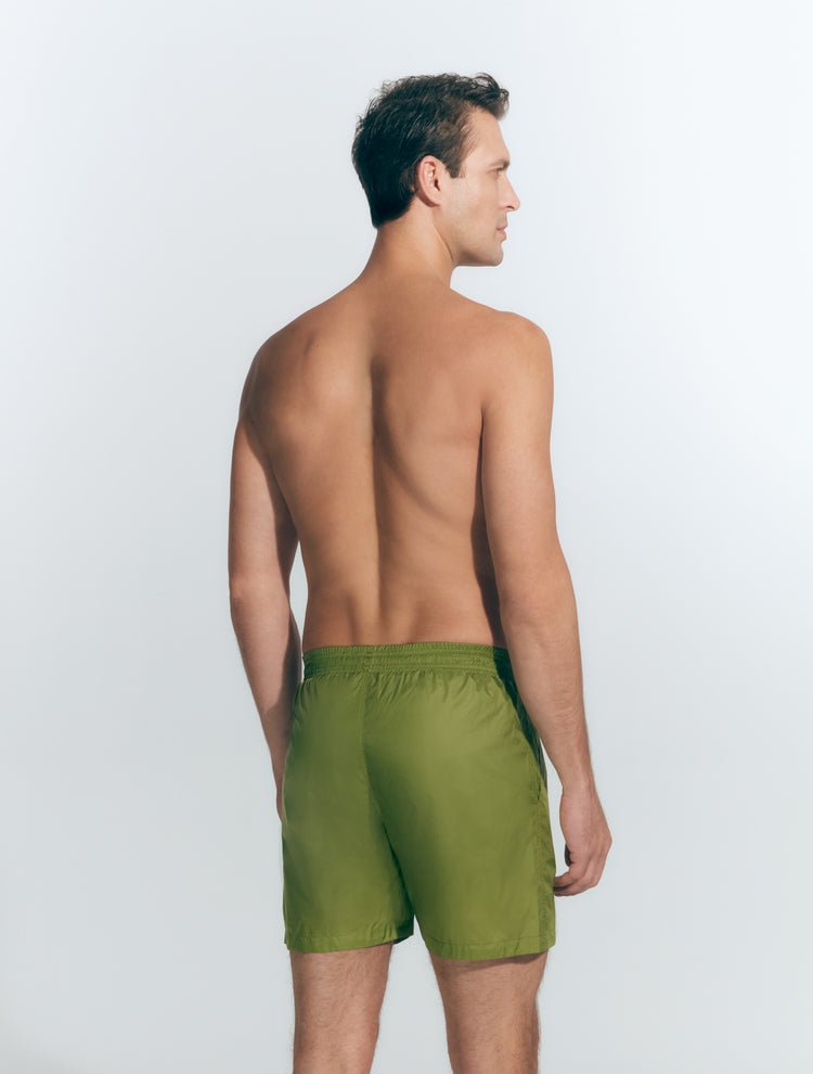 Back View: Model in Louis Olive Green Shorts - MOEVA Luxury Swimwear, Men Swim Shorts, Nikel, Mid Length Swim Shorts, Fully Lined, Slim Fit, Quick Dry, MOEVA Luxury Swimwear