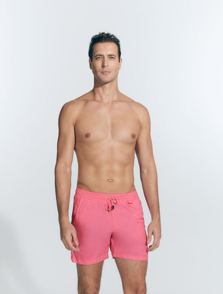 Front View: Model in Louis Pink Shorts - MOEVA Luxury Swimwear, Close Fitting, Lightweight Fabric with Quick Drying, Pockets at the Front, Drawstring Waist, Quick Dry,  MOEVA Luxury Swimwear