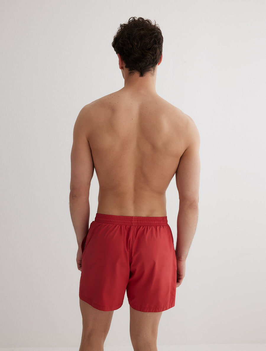 Back View: Model in Louis Red Shorts - MOEVA Luxury Swimwear, Men	Swim Shorts, Nikel, Mid Length Swim Shorts, Fully Lined, Slim Fit, Quick Dry, MOEVA Luxury Swimwear