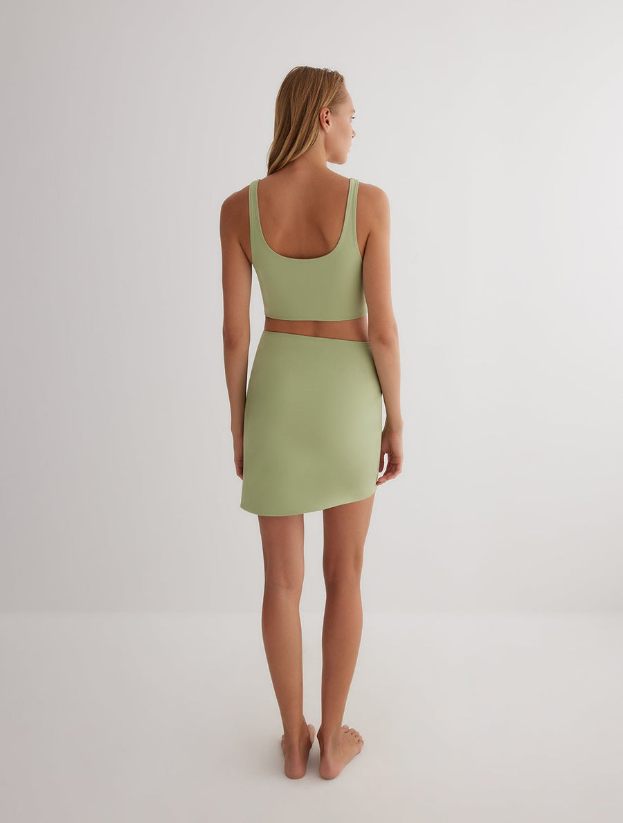 Back View: Model in Lupe Green/Nude Skirt - MOEVA Luxury Swimwear, Mid-Thigh Length, Stretchy Fabric, MOEVA Luxury Swimwear