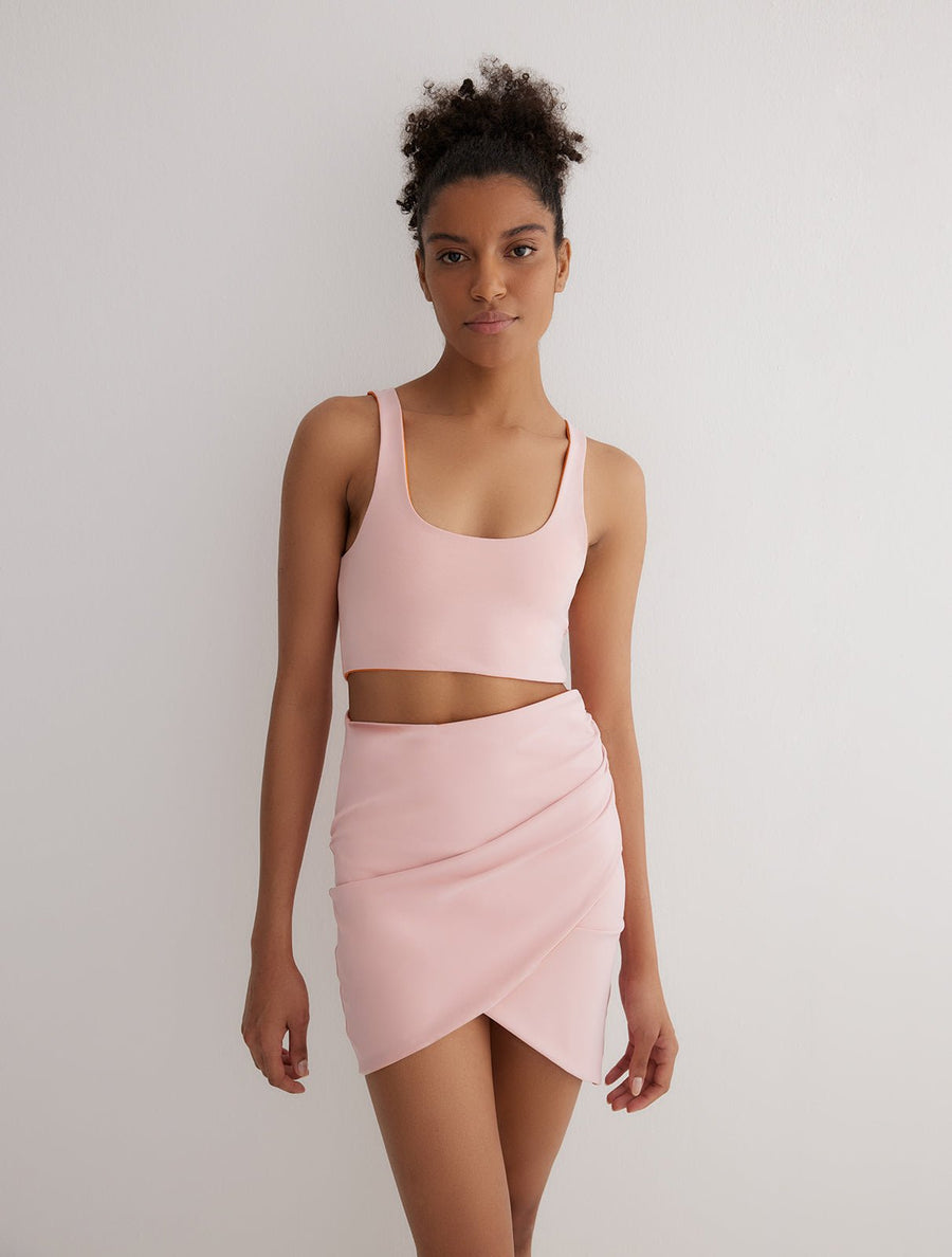 Front View: Model in Lupe Orange/Pink Skirt  - Wrapped Skirt, Slim Fit, MOEVA Luxury Swimwear
