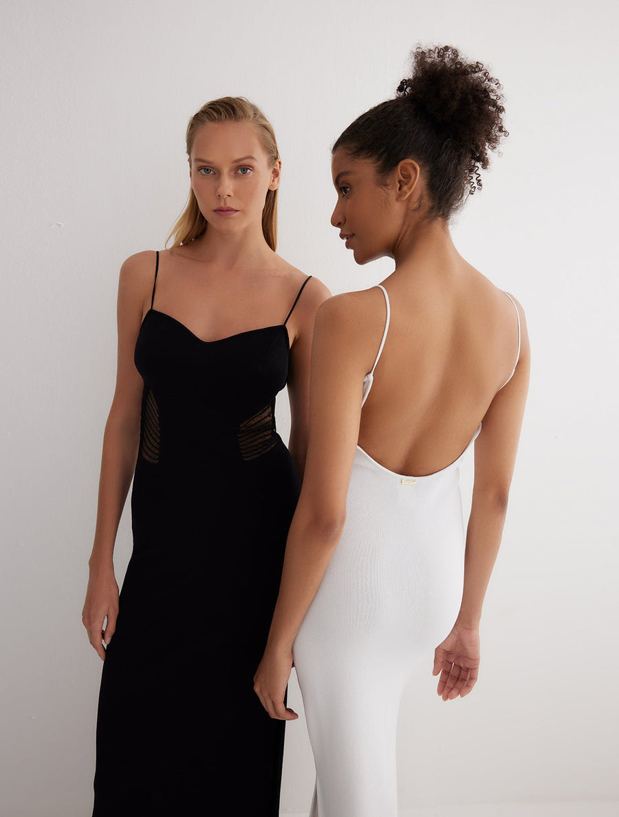 Back View: Model in Malin Black Dress - MOEVA Luxury Swimwear, Semi-Sheer Panels, Ankle Length, MOEVA Luxury Swimwear