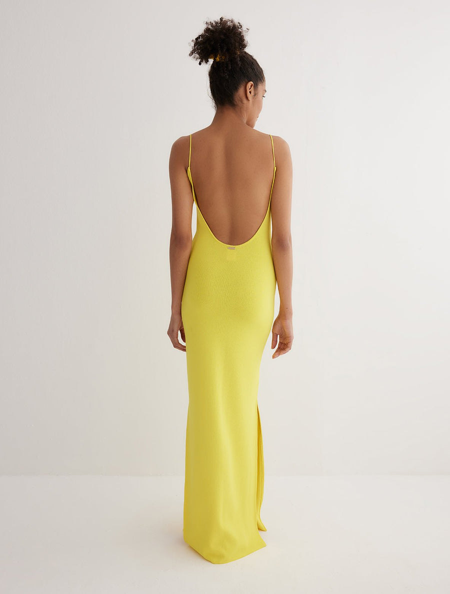 Back View: Model in Malin Yellow Dress - MOEVA Luxury Swimwear, Semi-Sheer Panels, Ankle Length, MOEVA Luxury Swimwear