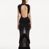 "Maris Black Dress from the back, focusing on the low back design adorned with twinkling gold clasps. "