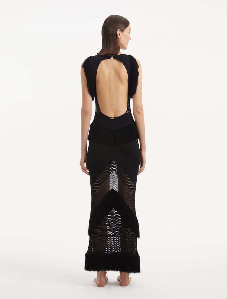 "Maris Black Dress from the back, focusing on the low back design adorned with twinkling gold clasps. "