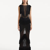 "Maris Black Dress from the front, showcasing the lustrous mesh knit fabric, high neckline, and full-length design. "