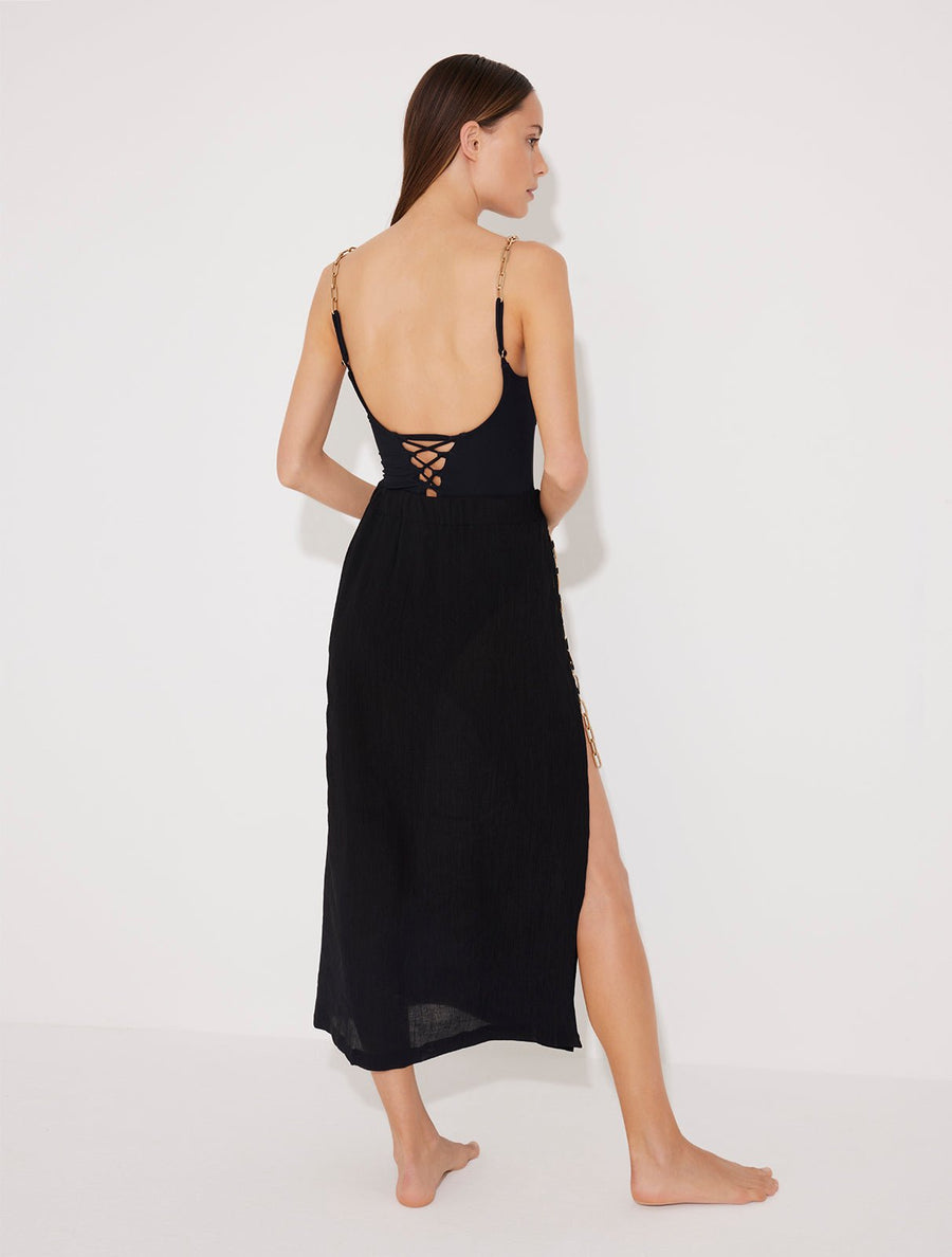 Back View: Model in Maritza Black Skirt - MOEVA Luxury Swimwear, Maxi Skirt, Unlined,Chic, Accessorised, Soft Touch Fabric, High Rise Ankle Length Beachwear, MOEVA Luxury Swimwear