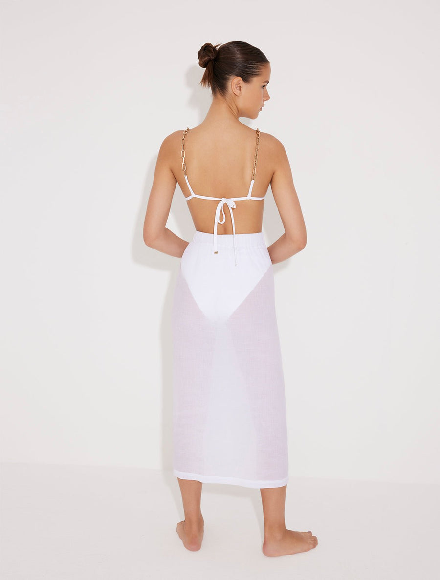 Back View: Model in Maritza White Skirt - MOEVA Luxury Swimwear, Maxi Skirt, Unlined,Chic, Accessorised, Soft Touch Fabric, High Rise Ankle Length Beachwear, MOEVA Luxury Swimwear