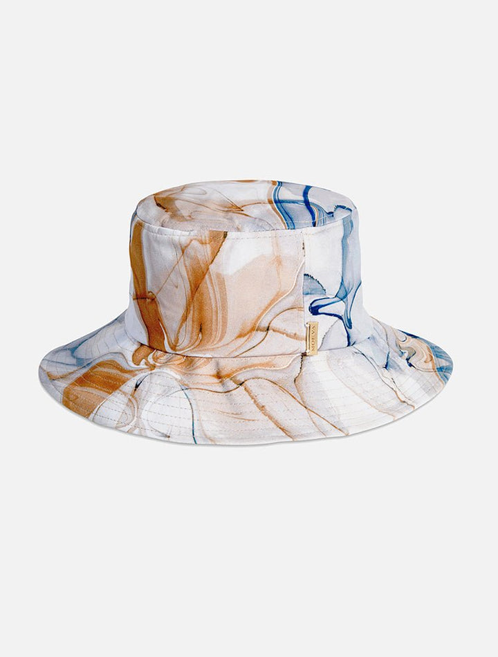 Front View: Miami Blue Abstract Bucket Hat - MOEVA Luxury Swimwear, Gold, Straw, Swimwear Fabric Bucket Hat, Signature Moeva Patch at Front, Classic Sillhouette, Quilted Brim, Quick Dry, Lined, 72% Polyamide 28% Elastane, MOEVA Luxury Swimwear 