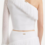 Monroe White One-Shoulder Knit Top with Fringe & Mesh Sleeve | Moeva | RTW Bustiers | Each week unveils new pieces—luxury swimwear, fluid resort silhouettes, and elevated summer-to-evening essentials designed to carry you from coastal escapes to city nights.