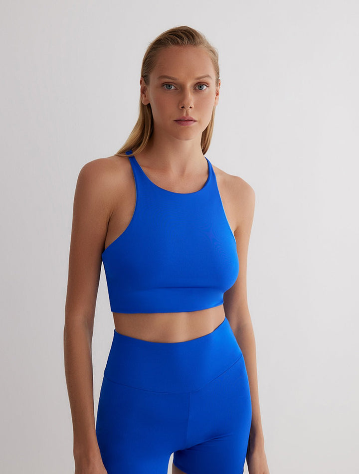 Front View: Model in Nela Blue/Baby Blue Reversible Top - MOEVA Luxury Swimwear, Ready to Wear Top, Fully Lined, Comfort and Sportive, Reversible Stretchy Fabric, MOEVA Luxury Swimwear