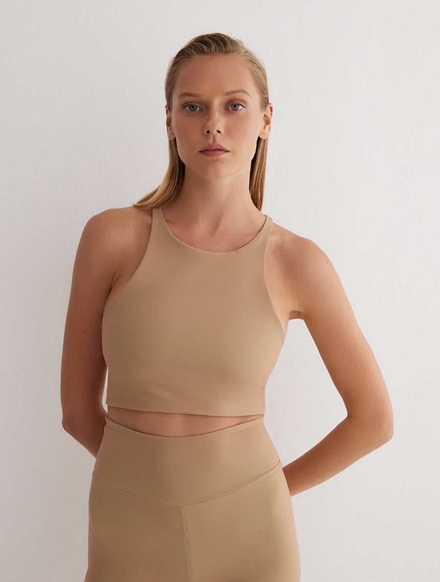 Front View: Model in Nela Green/Nude Reversible Top - 2 in 1 Reversible Top, Suitable for Swimming, UV Protection, High Neckline, MOEVA Luxury Swimwear