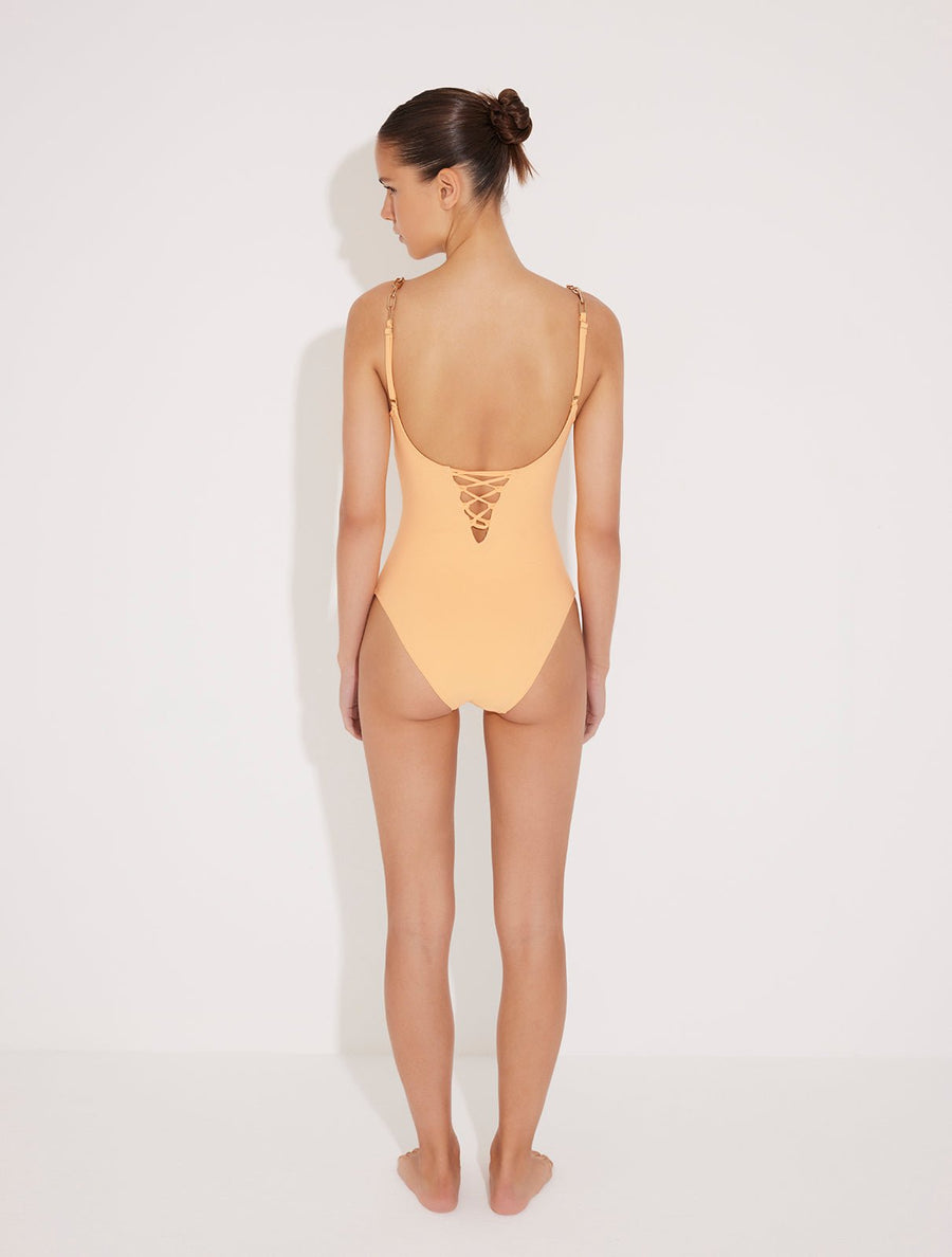 Back View: Model in Ninetta Orange Swimsuit - Lace-Up Back, Moderate Bottom Coverage, Fully Lined One Piece Swimsuit, MOEVA Luxury Swimwear 