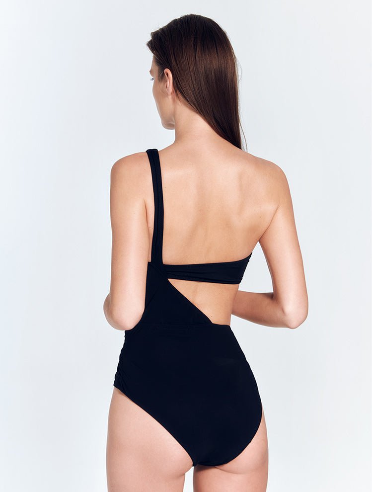 Back View: Model in Quinn Black Swimsuit- MOEVA Luxury Swimwear, Moderate Bottom Coverage, Lycra XtraLife® Certificate, Italian Fabric, One Piece Swimwear, MOEVA Luxury Swimwear