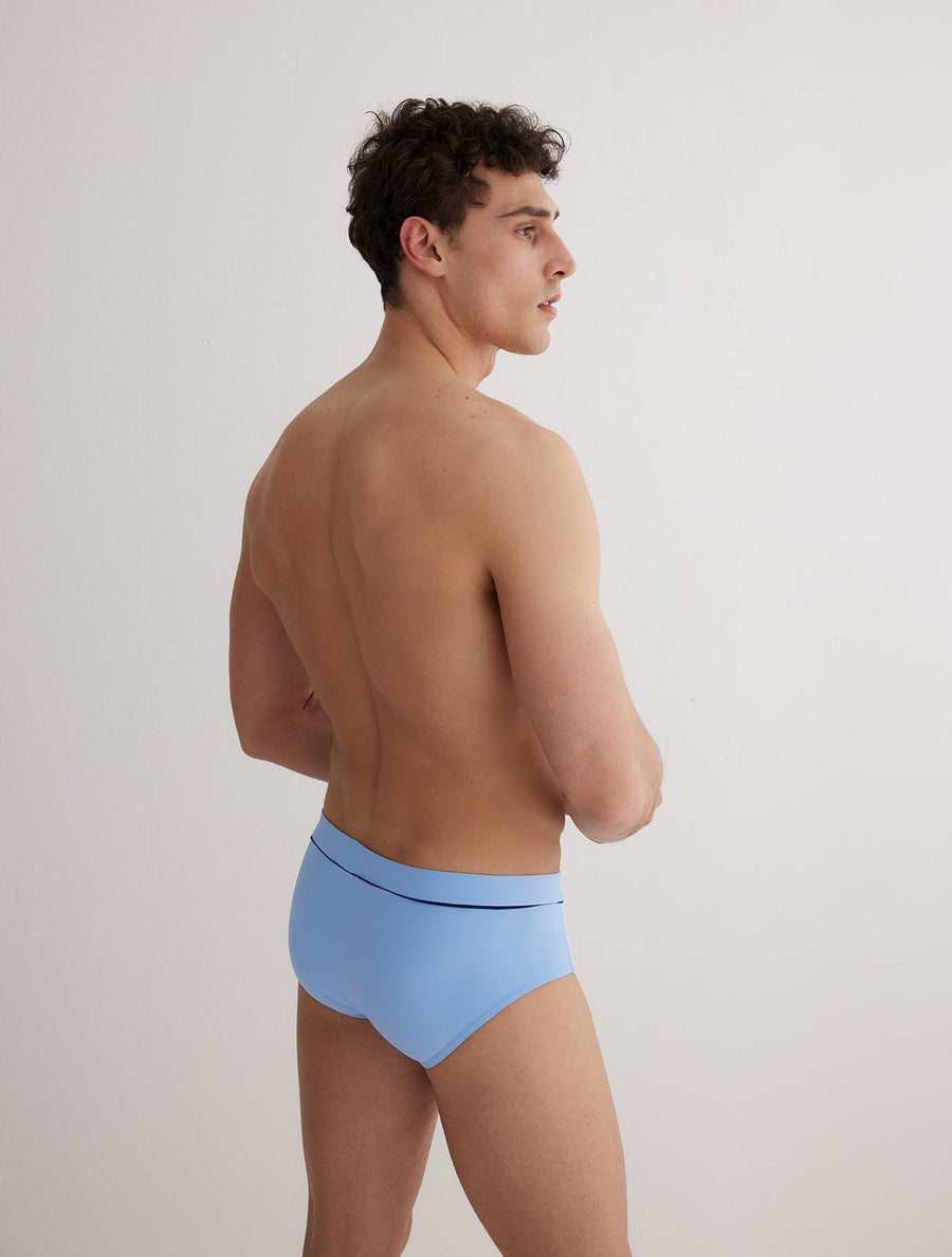 Back View: Model in Ricardo Baby Blue/Blue/White Briefs - MOEVA Luxury Swimwear, Swim Shorts, Nikel, Brief, Fully Lined, Slim Fit, Strech Classic, MOEVA Luxury Swimwear