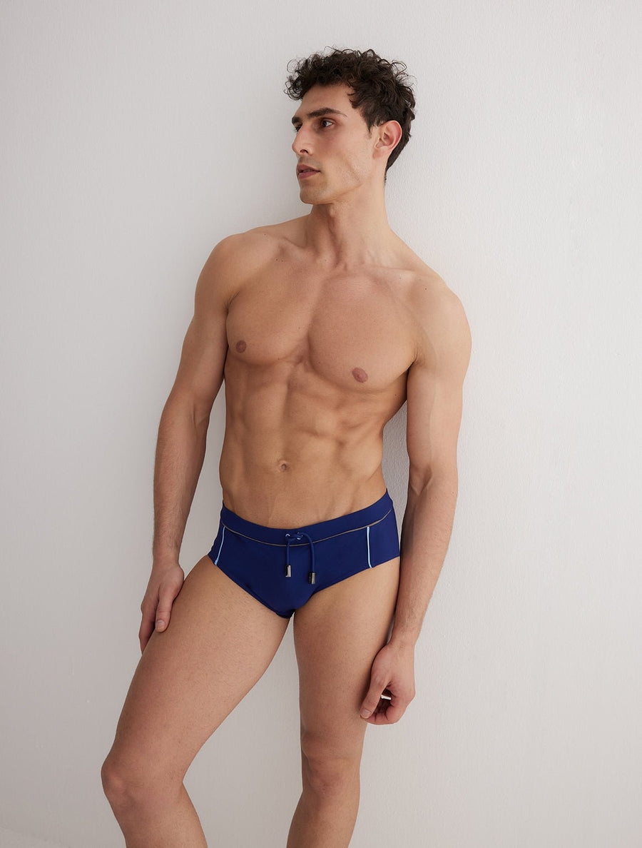 Front View: Model in Ricardo Blue/Grey/Baby Blue Briefs - MOEVA Luxury Swimwear, Duo/Tri-Colored, Elasticated Waistband, Strechy Fabric, Tie at the Front, Quick Dry, Comfortable Fit, MOEVA Luxury Swimwear