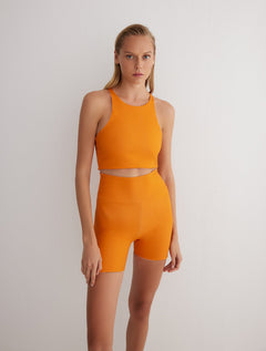 Front View: Model in Rocco Orange/Pink Reversible Shorts - MOEVA Luxury Swimwear, 2 in 1 Reversible Short, Suitable for Swimming, Elasticated Waistband, MOEVA Luxury Swimwear