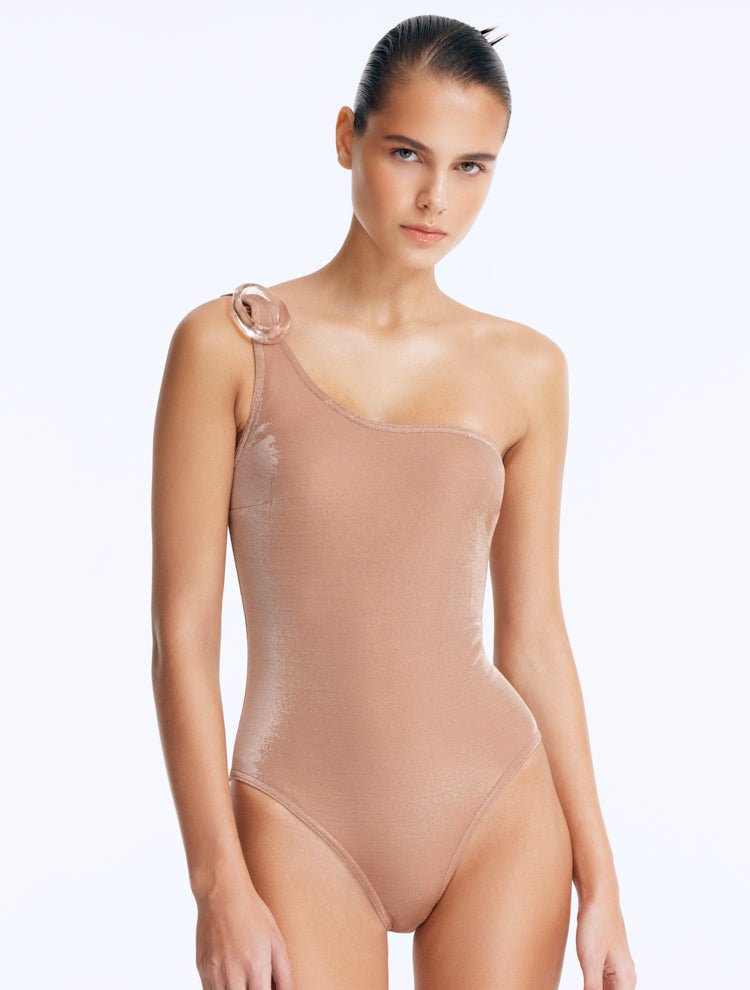 Front View: Model in Rowan Bronze Swimsuit - One Shoulder Silhouette, Chic Style, Clear Glass Hoop Accessory Detail, MOEVA Luxury Swimwear