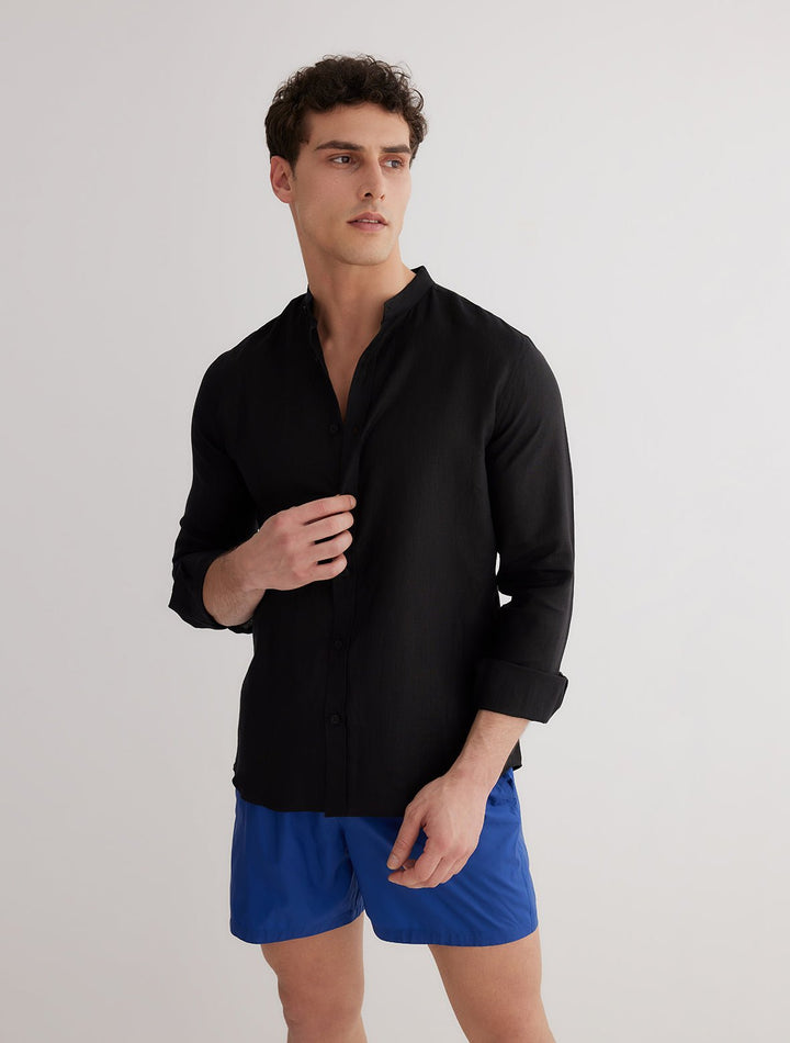 Front View: Model in Ryan Black Shirt - MOEVA Luxury Swimwear, Grandad-Collar, Buttoned Cuffs, Button Fastening, Tailored Italian Linen, Long-Sleeved, Slim Fit, MOEVA Luxury Swimwear