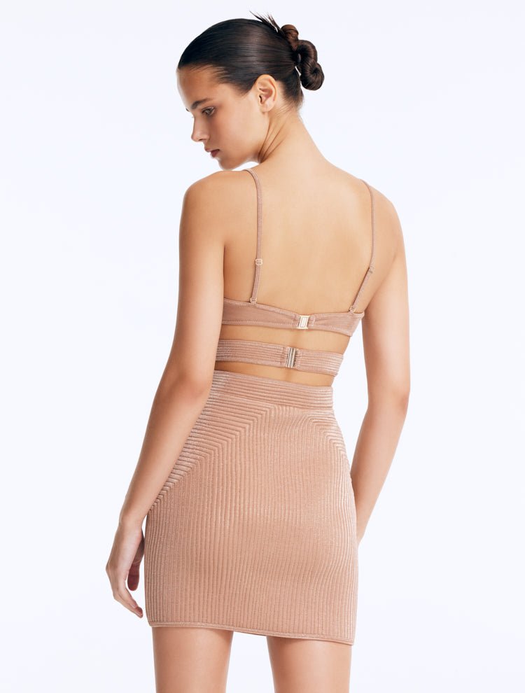 Back View: Rye Bronze Skirt on Model - Thigh Length, Topstitching Details, Made of Laminated Swimwear Fabric, MOEVA Luxury Swimwear