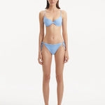 Salila Baby Side Tie Wave Textured Blue Bikini Bottom | Moeva | Bikini Bottom | Each week unveils new pieces—luxury swimwear, fluid resort silhouettes, and elevated summer-to-evening essentials designed to carry you from coastal escapes to city nights.
