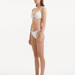 Salila White Side Tie Wave Textured Bikini Bottom | Moeva | Bikini Bottom | Each week unveils new pieces—luxury swimwear, fluid resort silhouettes, and elevated summer-to-evening essentials designed to carry you from coastal escapes to city nights.