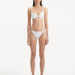 Salila White Side Tie Wave Textured Bikini Bottom | Moeva | Bikini Bottom | Each week unveils new pieces—luxury swimwear, fluid resort silhouettes, and elevated summer-to-evening essentials designed to carry you from coastal escapes to city nights.