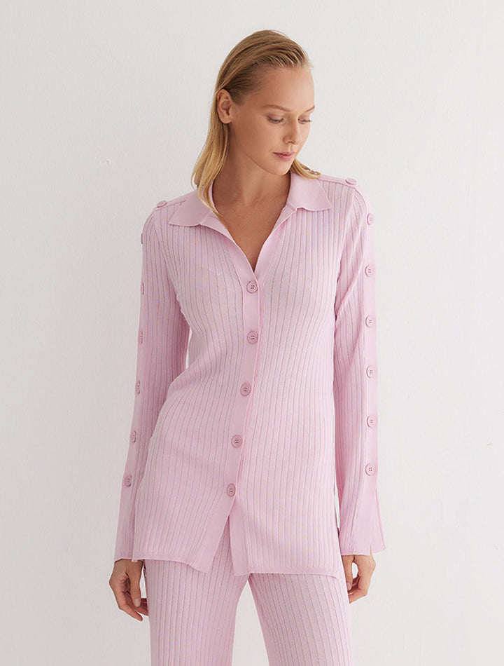 Front View: Model in Salome Pink Shirt - MOEVA Luxury Swimwear, Knitted Shirt, Long Sleeved, Button Details Along Sleeves and Front, Close Fit, MOEVA Luxury Swimwear