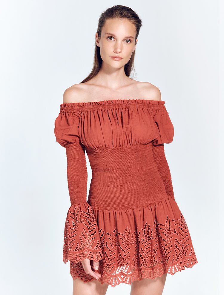 Front View: Model in Solange Red Orche  Dress - MOEVA Luxury Swimwear, Ruched Neckline, Elasticated Off-The-Shoulder, Off The Shoulder Dress, Long Shirred Puff Sleeves, Cotton Dress, MOEVA Luxury Swimwear