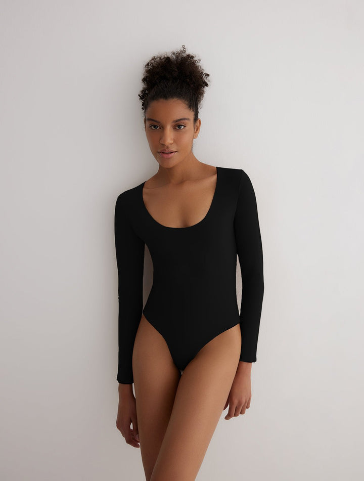 Front View: Model in Ulrika Black/Camel Reversible Bodysuit - MOEVA Luxury Swimwear, 2 in 1 Reversible Bodysuit, Suitable for Swimming, Scoop Neckline, MOEVA Luxury Swimwear