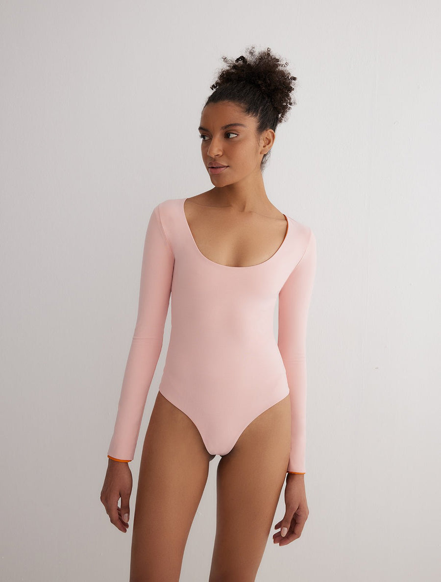 Front View: Model in Ulrika Orange/Pink Reversible Bodysuit - MOEVA Luxury Swimwear, Stretchy Fabric, French & Italian Fabric, Special Lycra Xtralife Certificate, MOEVA Luxury Swimwear