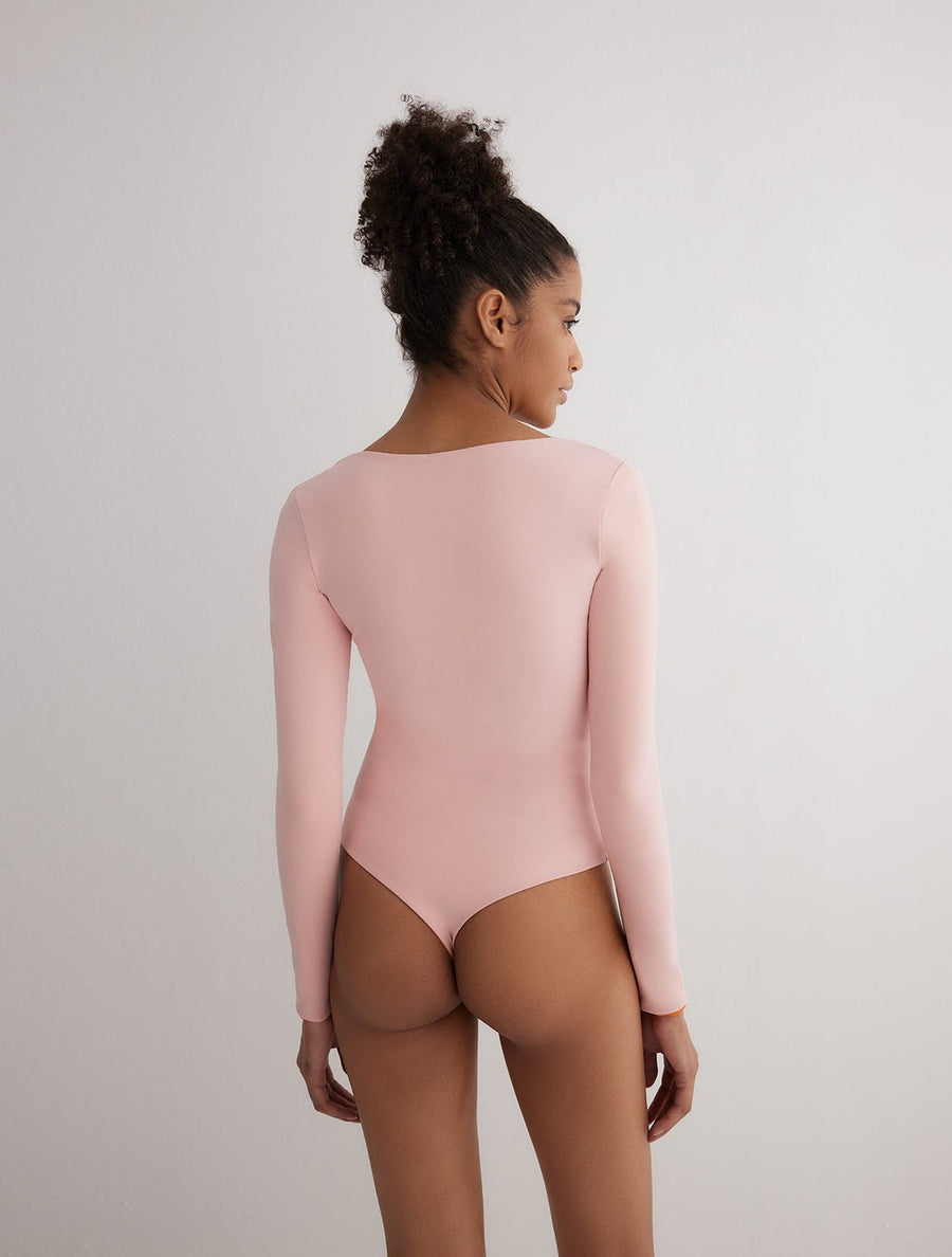 Back View: Model Ulrika Orange/Pink Reversible Bodysuit - MOEVA Luxury Swimwear, One Piece Bodysuits, Fully Lined, Comfort and Sportive, Reversible Stretchy Fabric, MOEVA Luxury Swimwear