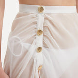 Xander White Sheer Maxi Skirt with Gold Button Details | Moeva | Beachwear Skirts | Each week unveils new pieces—luxury swimwear, fluid resort silhouettes, and elevated summer-to-evening essentials designed to carry you from coastal escapes to city nights.