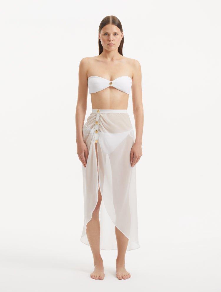 Xander White Sheer Maxi Skirt with Gold Button Details | Moeva | Beachwear Skirts | Each week unveils new pieces—luxury swimwear, fluid resort silhouettes, and elevated summer-to-evening essentials designed to carry you from coastal escapes to city nights.