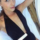 Shiny black one-piece swimsuit with a deep V-neck and gold-embellished belt.
