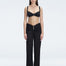 Front view of model wearing Angelique Black High-Rise Pants with layered panel and gold hoop accessory.
